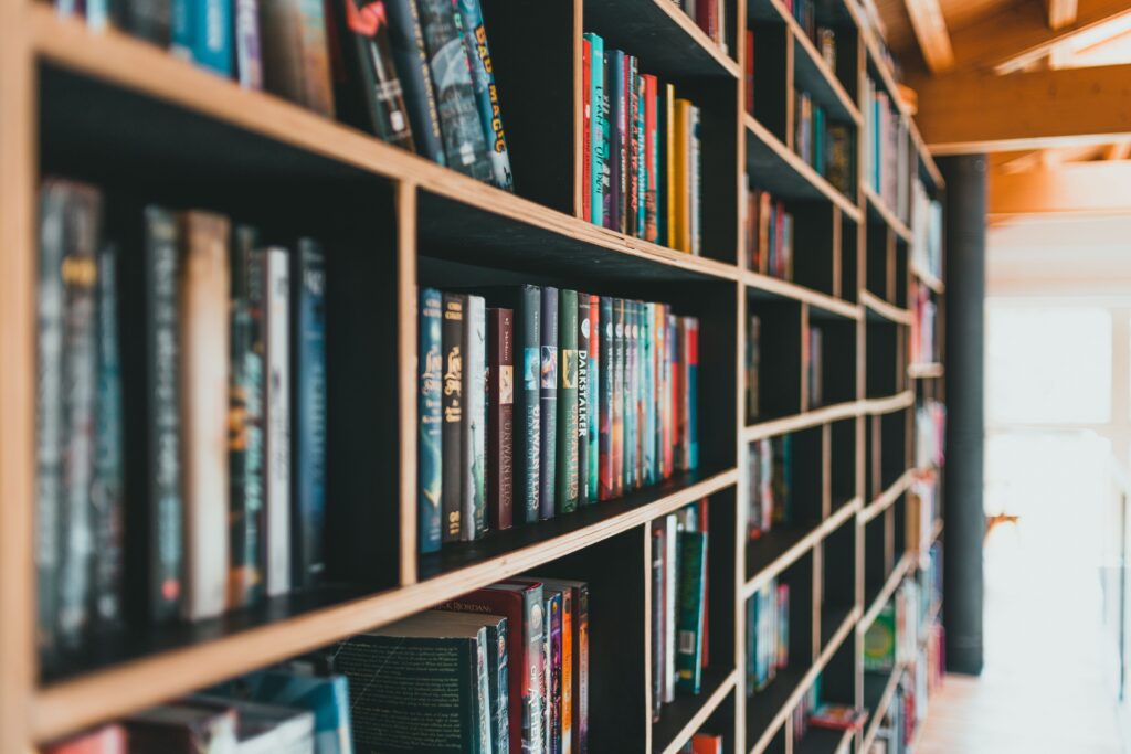 A photo of shelf filled with many different books